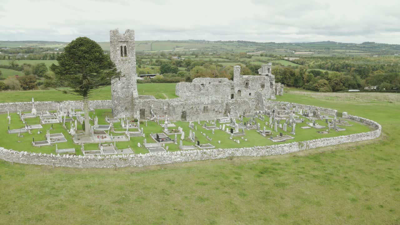 Hill of Slane monastery ruins surrounded by green countryside in County Meath under cloudy skies