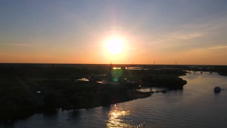 droning towards the uss north carolina while the sunsets behind the battleship