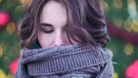 woman in a scarf near a christmas tree