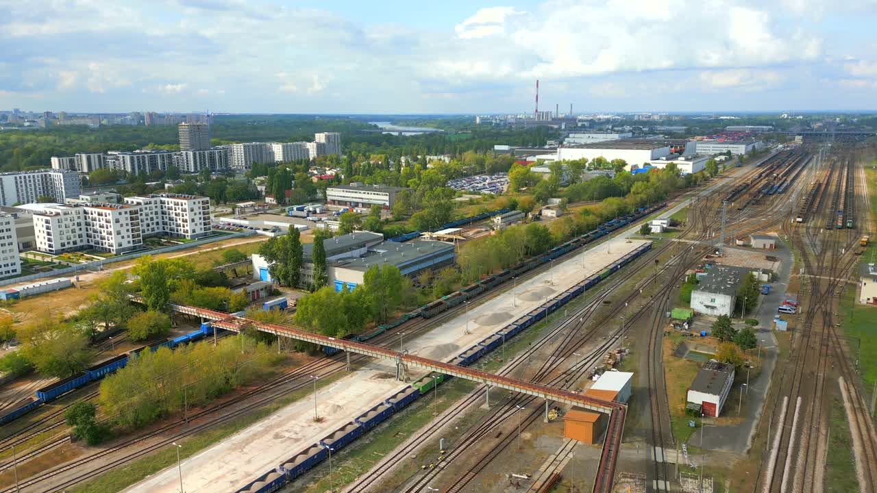 Residents rest, while train sits back, peacefully resting by empty track