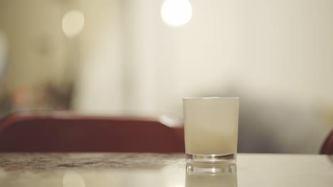 candle on a glass with shimmering flames