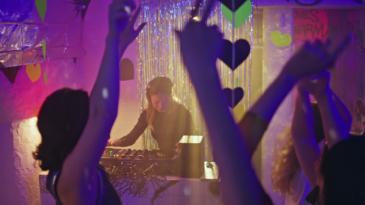 Vibrant party crowd dancing with uplifted hands creating atmosphere of joyous