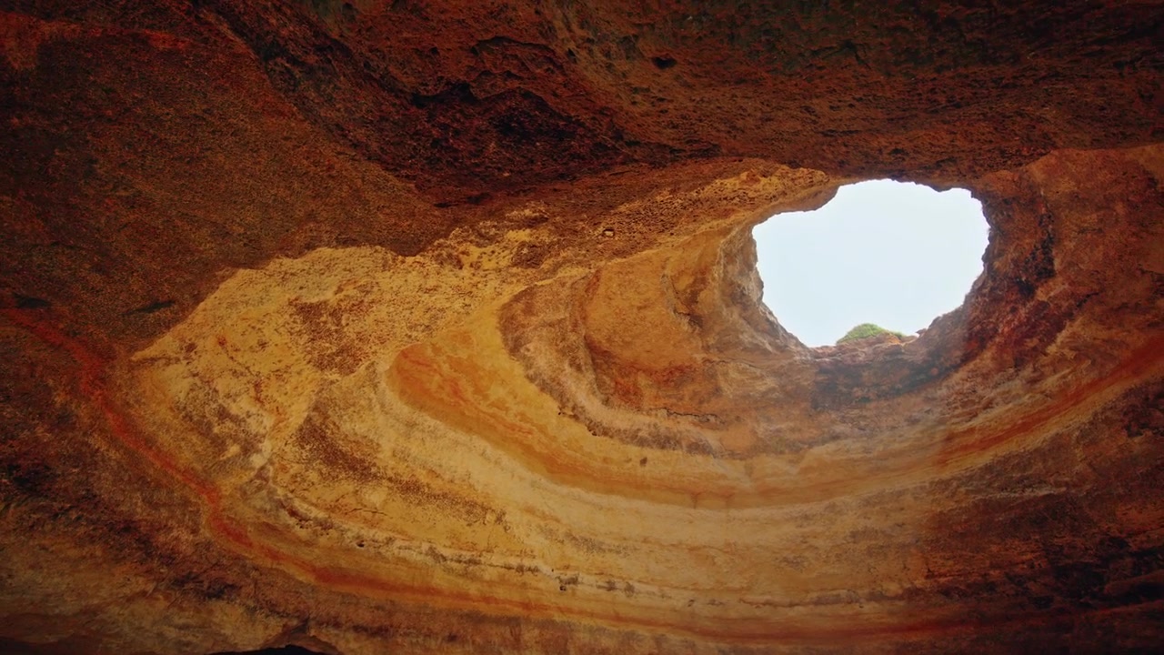 Sunlight Streaming Through Hole in Ceiling of Benagil Sea Cave