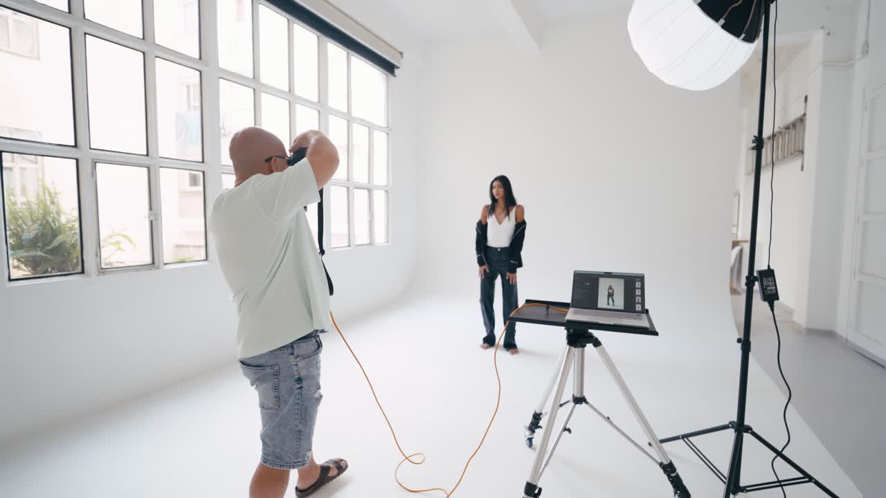 Photographer taking photos of model in studio