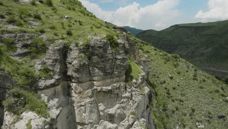 approaching into craggy landscape at the mountains near khertvisi fortress, southern georgia