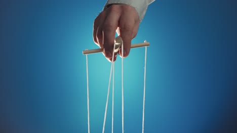 Hand manipulating puppet strings
