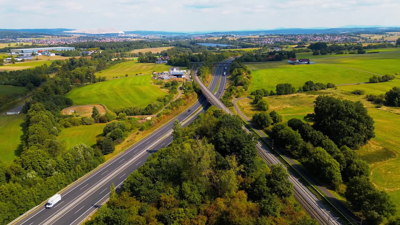 Highway and Railway Passing Through Green Countryside Landscape