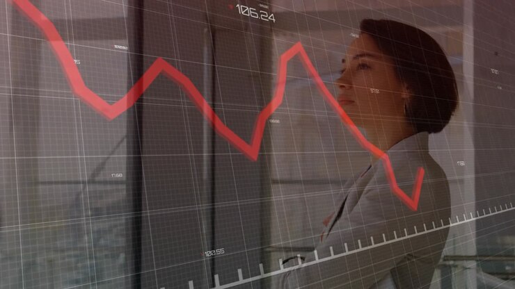 Woman exec tapping tablet and showing moving red chart and ticks, studying market decline by window