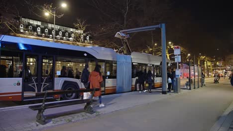 electric bus charging renewable energy at the station in the evening