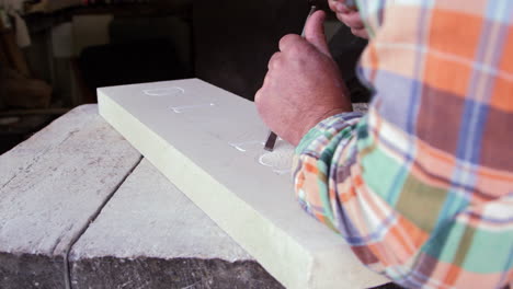 Stone-Mason-At-Work-On-Carving-In-Studio-Shot-On-RED-Camera