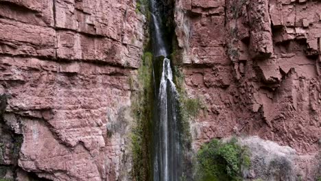 perolniyoc powerful waterfall flowing out from rocky cliff, sacred valley in cusco, perú