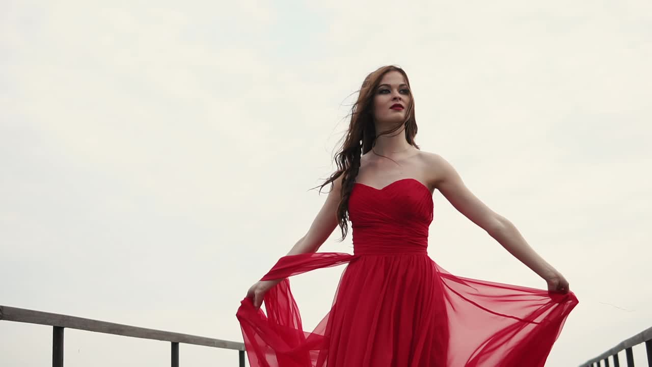 Woman in Red Dress on Bridge
