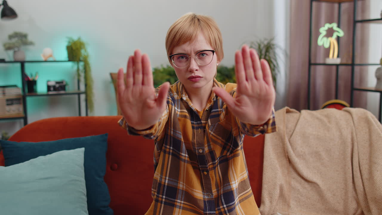 Angry woman say no hold palm folded crossed hands warning of finish stop gesture declining talk