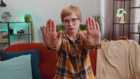 angry woman say no hold palm folded crossed hands warning of finish stop gesture declining talk