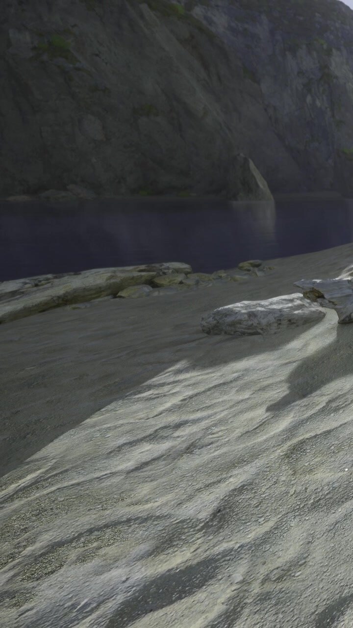 Sand and rocks near a calm water body in scenic outdoor setting