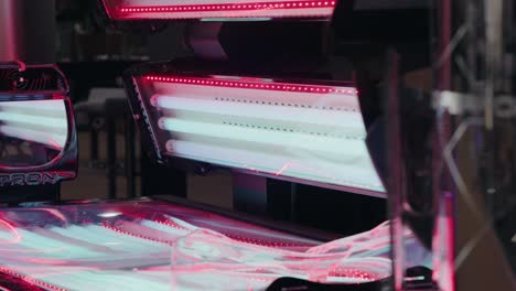 open tanning bed with glowing ultraviolet lamps and reflective surface