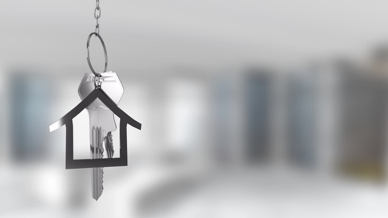 House-shaped keychain with keys in focus, blurred background