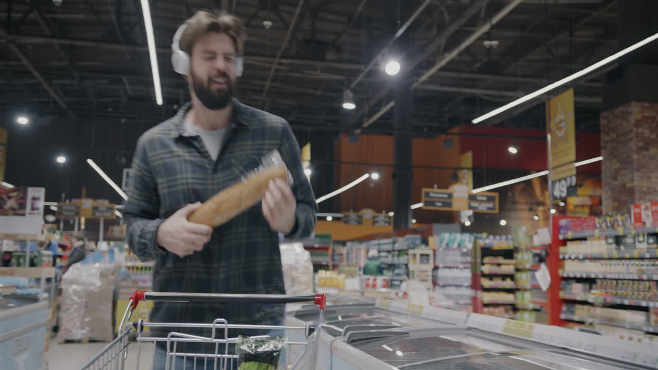 Man Dancing While Shopping for Bread in a Grocery Store