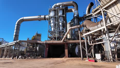 wide panning shot revealing a huge wood pellet processing plant