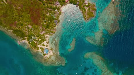 Aerial-shot-the-an-island-in-the-ocean-surrounded-by-corals,-in-Colombia,-Cartagena