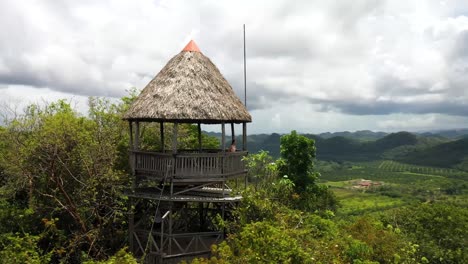 Fit-Girl-Hiking-to-Jungle-Mountain-Gazebo-Aerial-Shot