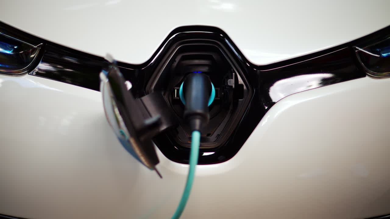 Close up of a white electric car charging
