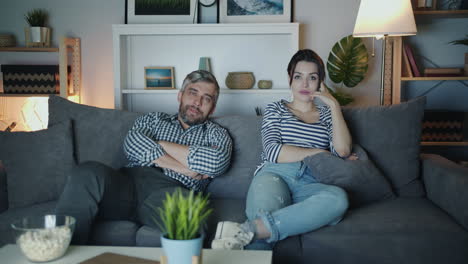 couple relaxing on couch at night