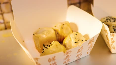 delicious fried buns in takeaway boxes