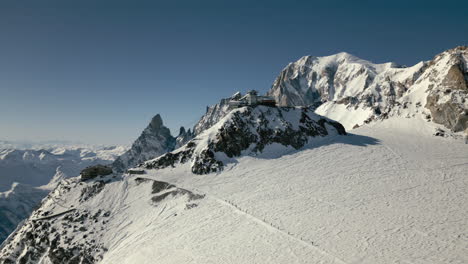 High-alpine-cableway-with-mont-blanc-and-group-of-mountaineers-aerial