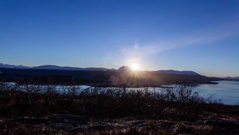 the sun rising over tromsø in northern norway during autumn