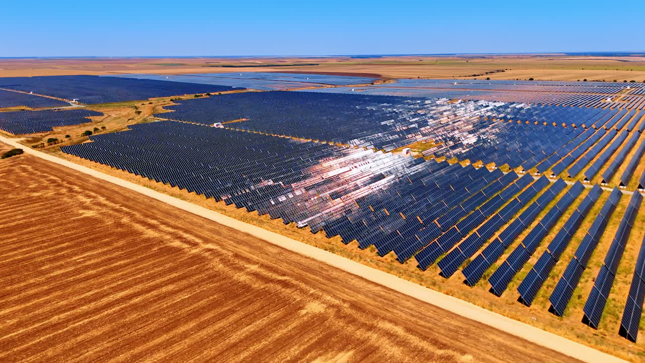 Multiple photovoltaic (PV) cells set in the vast fields. Solar panels used for green energy production. Aerial view
