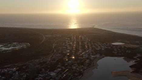 beautiful sunrise in the horizon from armona island in portugal - aerial shot