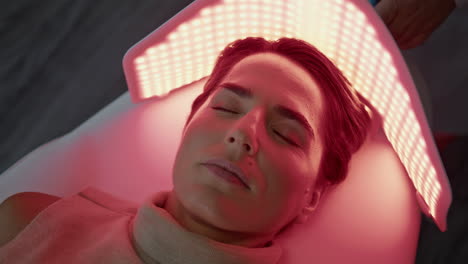 woman lying led therapy in cosmetology clinic close up. photodynamic procedure.