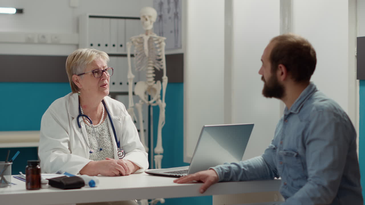 Medical specialist having conversation with patient at appointment