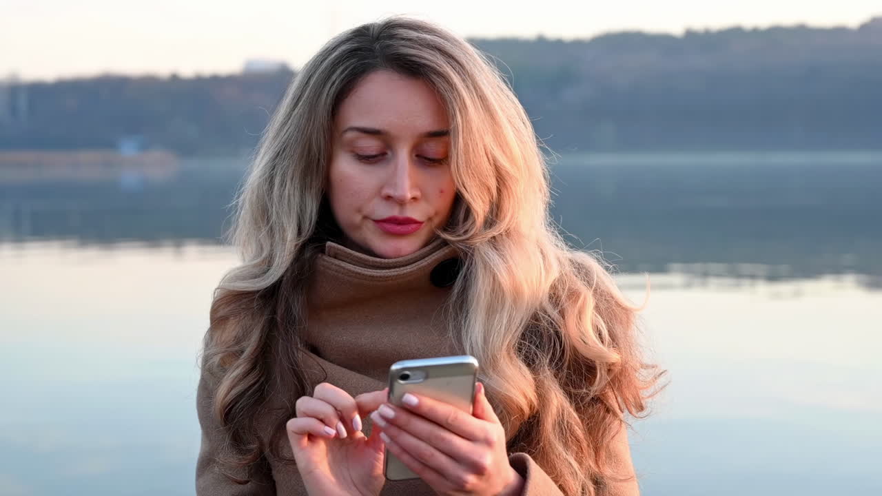 Serious woman looking in her phone in a park
