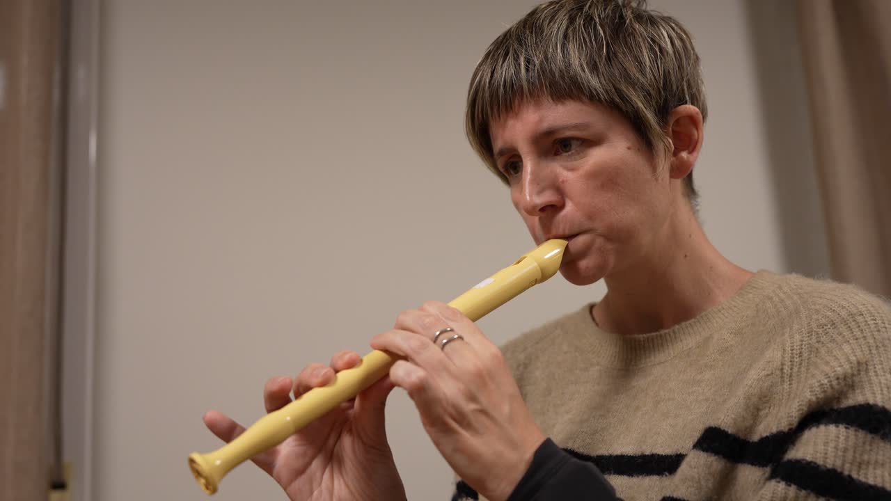 Primo piano di una donna che suona un flauto dolce