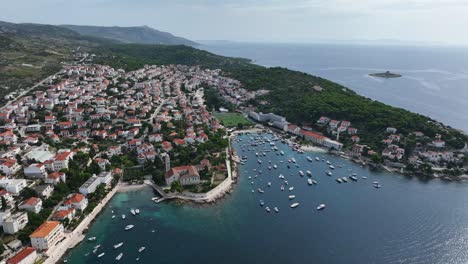 aerial establishing overview of hvar island, croatia, showcasing the coastline, blue waters, and historic town on stunning beautiful day