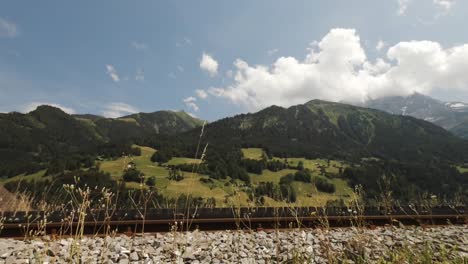 shot moving over grass to reveal green mountain landscape near val d'illiez, switzerland