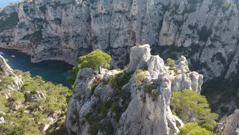 amazing drone shot flying between a trees and rocks discovering two man