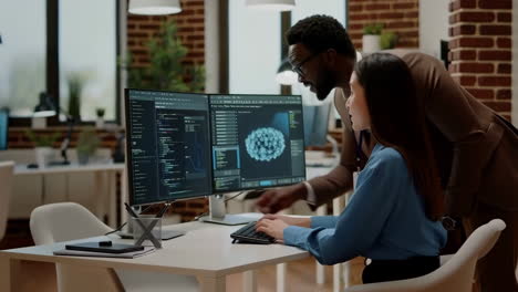 developers collaborating on code and 3d modeling in an office