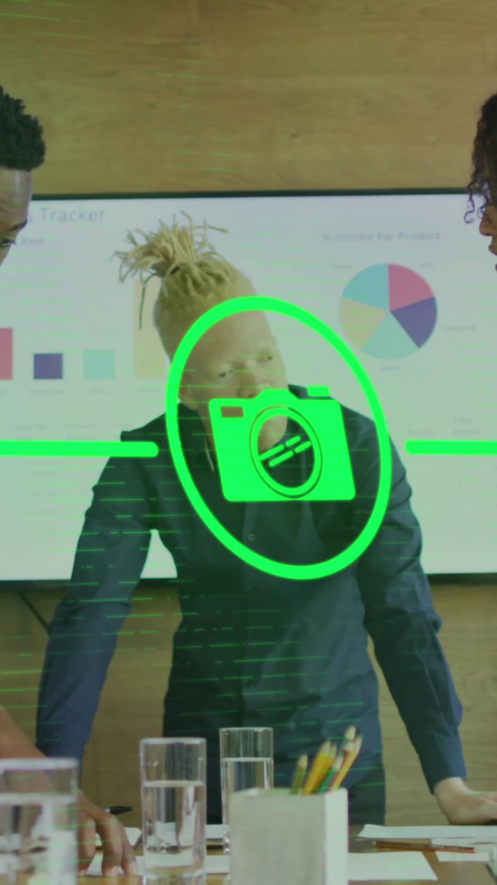 Animation of icons connected with lines over diverse coworkers discussing reports in office