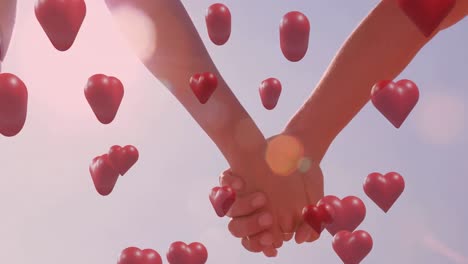 animation of red hearts over couple in love holding hands