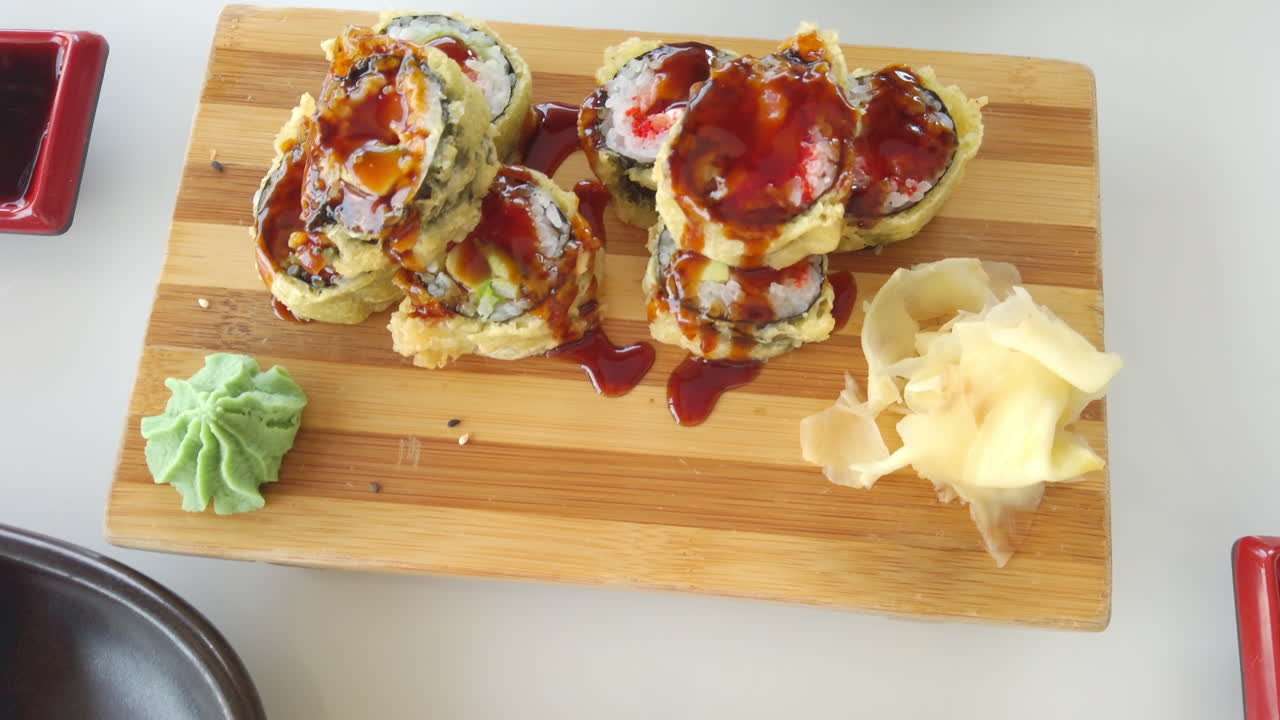 Close up of sushi rolls on wooden trays at a restaurant