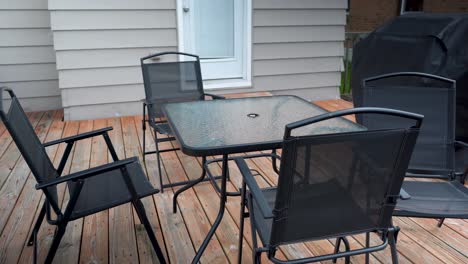 black-patio-furniture-on-brown-deck