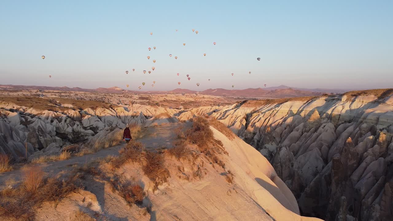 siguiendo a una joven en el famoso amanecer y los coloridos globos en capadocia, turquía