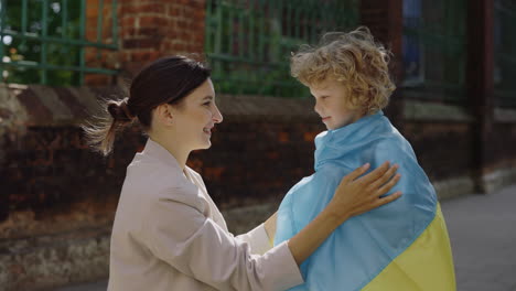 mother and son displaying the ukrainian flag