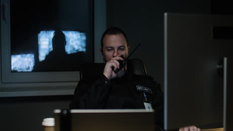 Man with walkie talkie in the hut at night