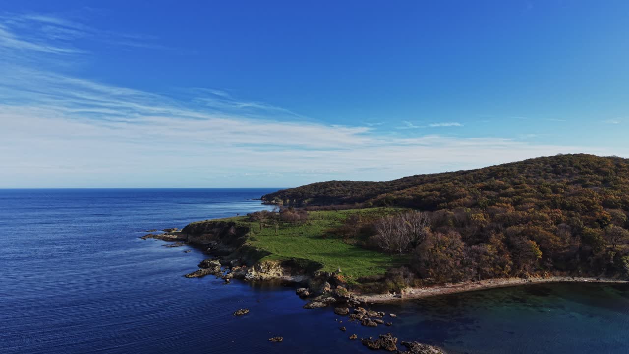 Aerial view of a serene coastal landscape with lush greenery