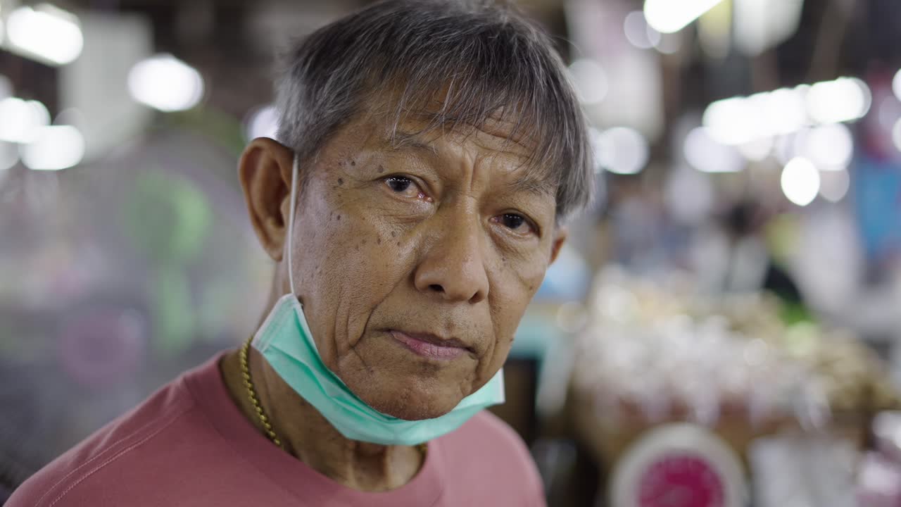 Portrait of a Senior Man Wearing a Mask in a Market