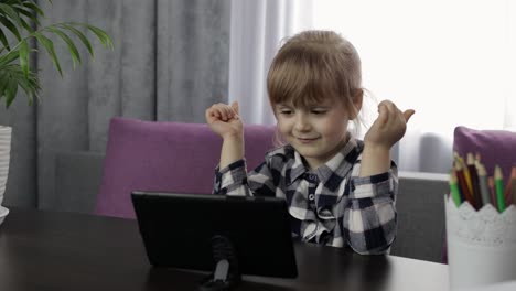 Girl-doing-online-homework-using-digital-tablet-computer.-Distance-education